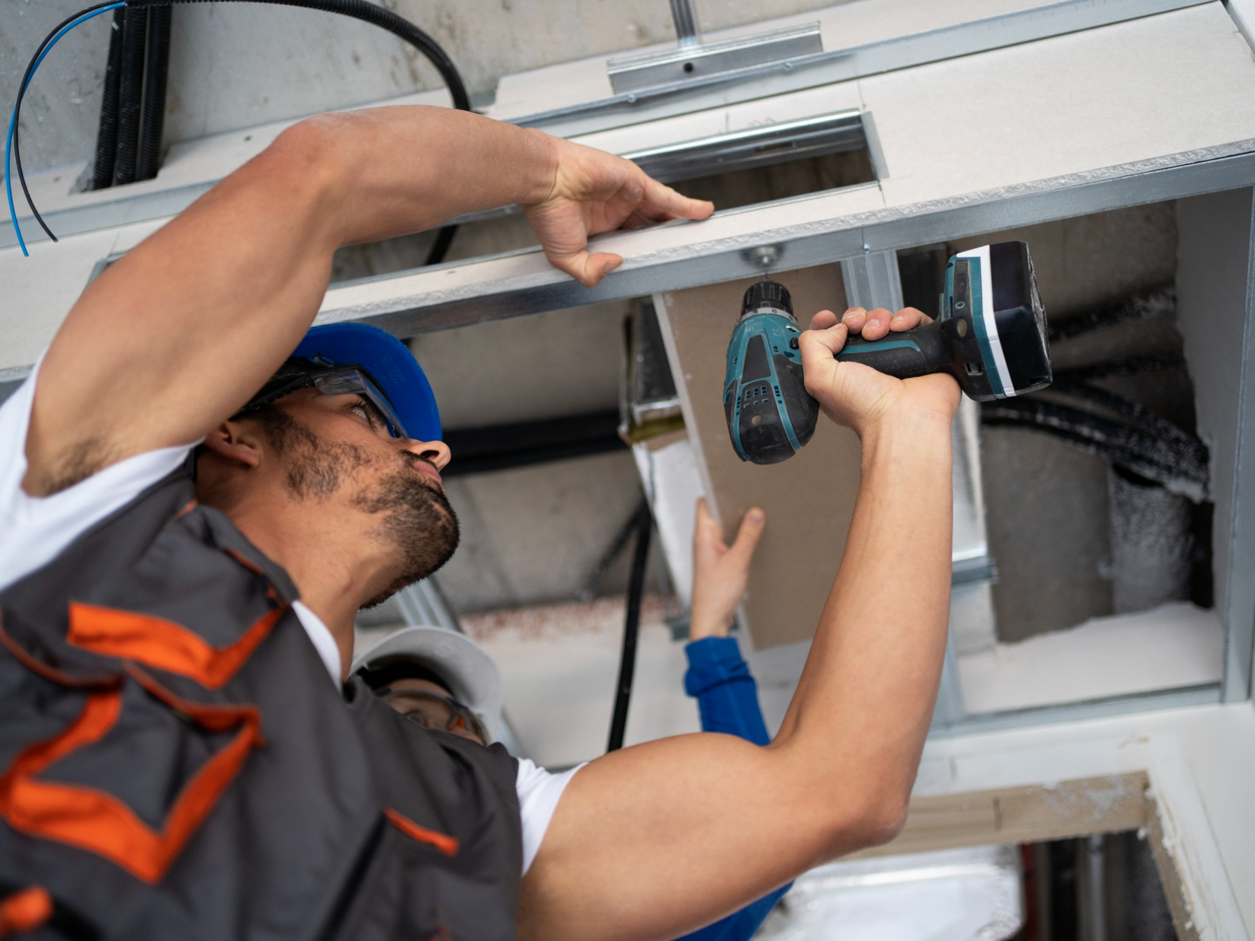 Technician installing a new garage door step by step, showing the garage door installation process