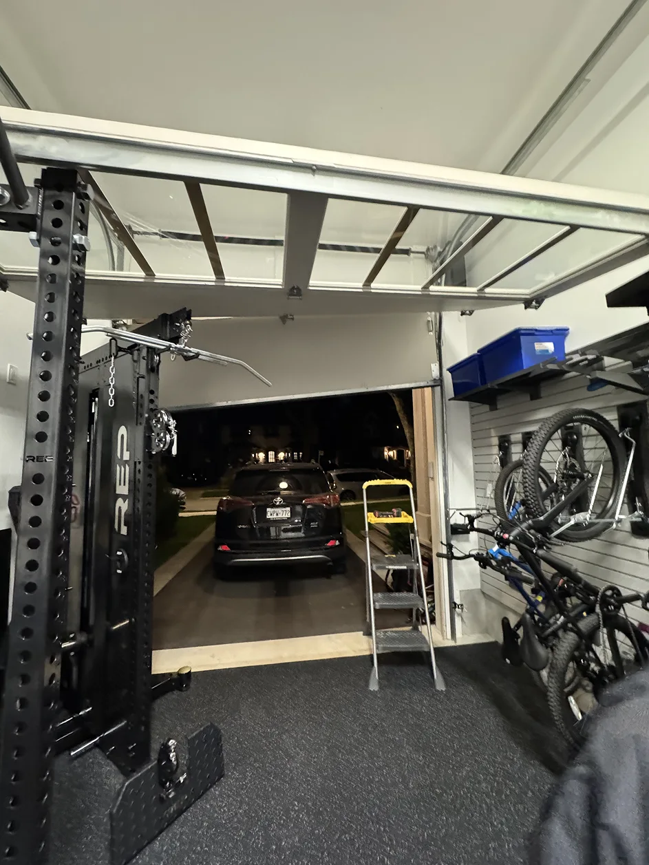 Garage with full ceiling clearance showing open door and overhead track system